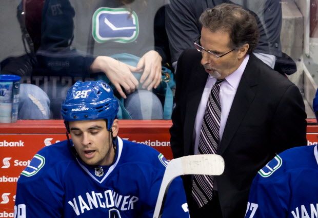 Vancouver Canucks' head coach John Tortorella, right, yells at Tom Sestito during third period NHL hockey action against the Buffalo Sabres in Vancouver, on Sunday March 23, 2014. THE CANADIAN PRESS/Darryl Dyck