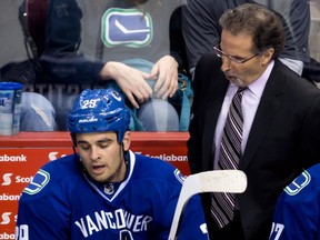 Vancouver Canucks' head coach John Tortorella, right, yells at Tom Sestito during third period NHL hockey action against the Buffalo Sabres in Vancouver, on Sunday March 23, 2014. THE CANADIAN PRESS/Darryl Dyck