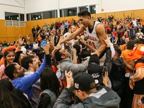 Jitinder Lohcham of the CCAA national champion Langara College Falcons enjoys a victory ride from fans of the Vancouver team following triumphant victory Saturday at Squamish's Quest University. (Paul Yates, Vancouver Sports Pictures)