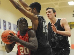 Holy Cross' Jonathan Kongbo (left) battles the Pitt Meadows Marauders during action at the Gleneagle Talons Invitational  in December. (PNG photo)