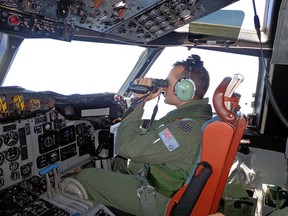Pilot of a Royal Australia Air Force AP-3C Orion maritime patrol aircraft scans the surface of the sea during a search operation for the missing Malaysia Airlines Flight MH370 to the west of the Malaysian Peninsula. The Australians are searching 600,000 square kilometres of the remote Indian Ocean for the missing airliner. (AFP/ ROYAL AUSTRALIAN AIRFORCE PHOTO)
