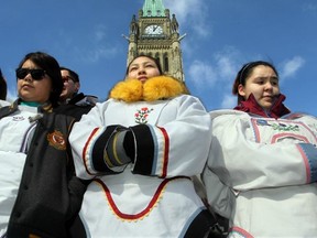 Girls from Ottawa’s Sivuniksivut school, dressed in traditional Amautis, were among 200 people on Parliament Hill March 5 to hold a vigil for missing and murdered indigenous women. Native women recently delivered a petition with 23,000 signatures to Parliament, demanding a national inquiry into the issue. (POSTMEDIA NEWS FILES)