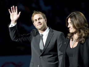 Markus Naslund and his wife Lotta wave to the crowd during a ceremony to retire his jersey on Dec. 11, 2010 at Rogers Arena. (Photo by Rich Lam/Getty Images)