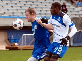UBC's Niall Cousens (left) fends of Kareem Moses of FC Edmonton during 1-1 friendly Saturday in Vancouver. (Richard Lam, PNG Photo)