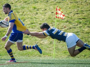 UBC Thunderbird Sean Ferguson, left tries to out run Cal Golden Bears' Andrew Battaglia, right during the "World" Cup at Thunderbird Stadium in Vancouver Sunday March, 23, 2014  (Ric Ernst / PNG)