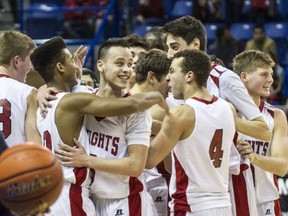 The St. Thomas More Knights celebrate a B.C. Triple A senior boys basketball championship victory on Saturday night in Langley. (Steve Bosch, PNG)