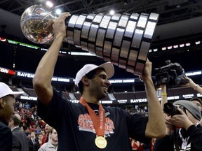 Ex-Vancouver College star Thomas Scrubb celebrates the spoils of victory as Carleton wins another CIS men's basketball title on Sunday. (CP photo)