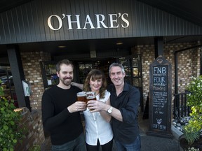 Toasting the new Brewed Awakening tap at O'Hare's GastroPub in Richmond with operators Erinn and Grant Bryan and pints of Four Winds Phaedra.