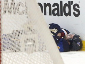 St. Louis Blues center David Backes lies on the ice after taking a hit from Chicago Blackhawks defenseman Brent Seabrook in the third period of Game 2 of a first-round NHL hockey playoff series on Saturday, April 19, 2014, in St. Louis. Backes was tended to by a trainer and left the ice under his own power. (AP Photo/St. Louis Post-Dispatch, Chris Lee)