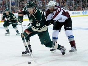 Matt Cooke (24) of the Minnesota Wild shoots the puck against P.A. Parenteau of the Colorado Avalanche during Game 3 of the first round of the NHL playoff series with Colorado on Monday in Minnesota.  (Photo by Hannah Foslien/Getty Images)