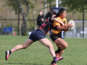 Abbotsford's swarming defence was too much for the Shawnigan Lake women in the 2014 BC High School girls' sevens final. (Photo by Kim Stallknecht/PNG)