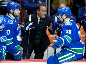 Vancouver Canucks head coach John Tortorella chats with Jannik Hansen (right) and Ryan Kesler on April 5, 2014 in a game against the Los Angeles Kings. CP photo.