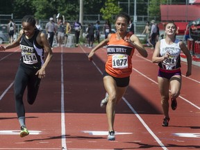 New Westminster's Raquel Tjernagel (centre) edges STM's Zion Corrales-Nelson at finish line of senior 100 metre final Friday in Langley. (Steve Bosch, PNG)
