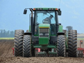 A Fraser Valley corn field is prepared for planting with tractor and cultipacker. The "cow" corn will be harvested in October and stored in bunkers to feed livestock through winter.