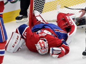 Carey Price lies on the ice after Chris Kreider of the New York Rangers crashed into the goalie in the second period of the Eastern Conference final of the N.H.L. playoffs at the Bell Centre in Montreal, on Saturday, May 17, 2014. (John Kenney / THE GAZETTE)