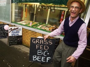 George Jackson places a chalk board sign advertising B.C. beef outside his shop, Jackson's Meats in Vancouver, in this Province file photo from 2003. A new phone app will connect consumers and vendors with the click of a button.