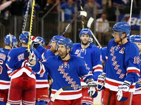 NEW YORK, NY - MAY 11:  Martin St. Louis #26 of the New York Rangers celebrates their 3 to 1 win over the Pittsburgh Penguins with teammates in Game Six of the Second Round of the 2014 NHL Stanley Cup Playoffs at Madison Square Garden on May 11, 2014 in New York City.  (Photo by Elsa/Getty Images)
