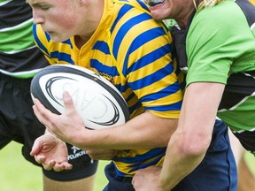 Collingwood's Owen Stout (left) us tackled by McRoberts' Nolan Howell during BC Double A semifinal action Thursday at Rotary Stadium in Abbotsford. (Ric Ernst, PNG photo)