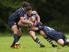 NORTH VANCOUVER. MAY Joe Reekie is tackled by a pair of James Bay AA players in the BC Provincial Rugby Final at Klahanie Park, North Vancouver. (Gerry Kahrmann/PNG Staff)