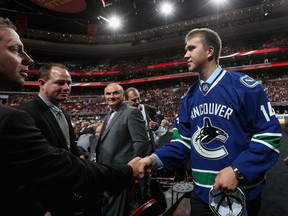 Nikita Tryamkin meets with his team after being drafted #66 by the Vancouver Canucks on Saturday.