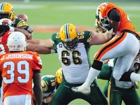 Stand clear, says super-sized Esks lineman Matthew O'Donnell as he holds off two Lions defenders Friday.