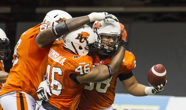 JUNE 28 2014. BC Lions T-Dre Player (with ball)  celebrates his touchdown with Rolly Lumbala against Edmonton Eskimos in CFL action at BC Place  in  Vancouver, B.C.  on June 28, 2014.   (Steve Bosch  /  PNG staff photo)