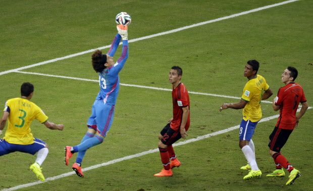 Mexico’s goalkeeper Guillermo Ochoa makes a save during the group A World Cup soccer match between Brazil and Mexico at the Arena Castelao in Fortaleza, Brazil, Tuesday, June 17, 2014. (AP Photo/Themba Hadebe)