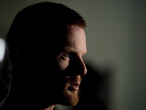 Vancouver Canucks Daniel Sedin of Sweden speaks with a reporter during the teams training camp at UBC arena in Vancouver, B.C. Thursday, Sept, 12, 2013. THE CANADIAN PRESS/Jonathan Hayward ORG XMIT: JOHV107