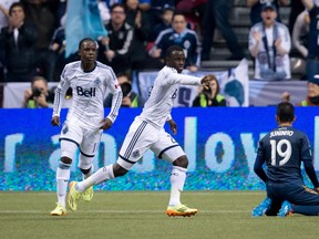 Vancouver Whitecaps' Kekuta Manneh, centre, of Gambia, celebrates after scoring the tying goal as teammate Darren Mattocks, left, of Jamaica, and Los Angeles Galaxy's Juninho, of Brazil, look on during second half MLS soccer action in Vancouver, B.C., on Saturday April 19, 2014. THE CANADIAN PRESS/Darryl Dyck