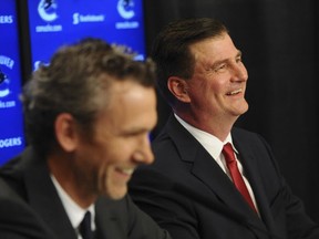 Jim Benning is introduced by team president Trevor Linden as the new general manager for the Vancouver Canucks in May 2014.