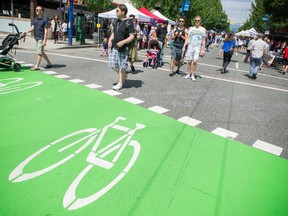 Road closures, bike lanes, parking restrictions and numerous summer events such as car-free day depicted above on Denman Street have reduced the quality of life in the West End, argues one reader. (Ric Ernst / PNG)