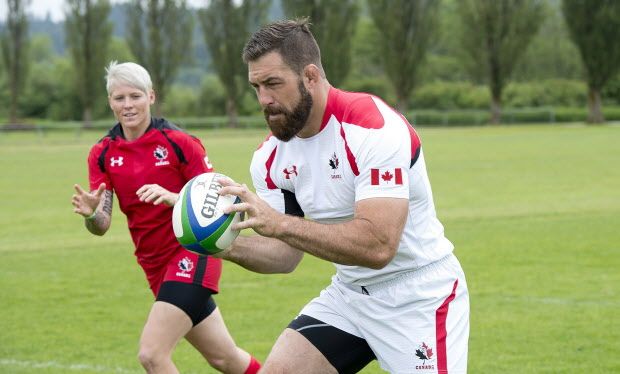 Rugby Canada team members Jamie Cudmore and Jen Kish wear their new uniforms at the team's practice facility in Burnaby, B.C. Tuesday, June, 3, 2014. THE CANADIAN PRESS/Jonathan Hayward ORG XMIT: JOHV104