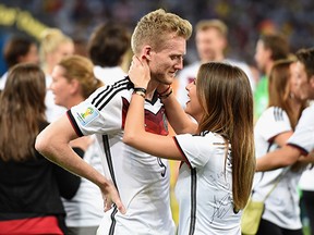 Andre Schürrle of Germany celebrates with girlfriend Montana Yorke after defeating Argentina 1-0 in extra time during the 2014 FIFA World Cup Brazil Final match.