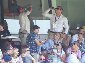 South Sydney Rabbitohs rugby league players Sam Burgess and Tom Burgess skull beers in the crowd during day two of the Fifth Ashes Test match between Australia and England at Sydney Cricket Ground on January 4, 2014 in Sydney, Australia.  (Photo by Mark Kolbe/Getty Images)