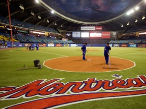 Grounds keepers from the Toronto Blue Jays prepare the field for preseason Major League Baseball game between the Blue Jays and the New York Mets at the Olympic Stadium in Montreal on Friday March 28, 2014.  (Allen McInnis / THE GAZETTE)
