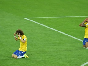 David Luiz and Luiz Gustavo are praying, we think, after their blowout loss to Germany. Part of that prayer: "Please, God, make the third-place game just go away."