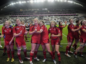 Andrea Burk (centre) and her Canadian teammates celebrate after their 18-16 win over France in the Women's Rugby World Cup semi final. FRED DUFOUR/AFP/Getty Images