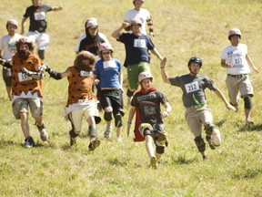 Racers chase a wheel of cheddar at the Canadian Cheese Rolling Festival on  Blackcomb Mountain.