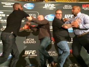 UFC light heavyweight champion Jon Jones (far left) and Daniel Cormier (far right) got into it at today's UFC 178 press event at the MGM Grand in Las Vegas.