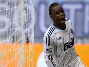 Vancouver Whitecaps' Darren Mattocks, of Jamaica, celebrates his goal against Sporting Kansas City during the first half of an MLS soccer game in Vancouver, B.C., on Sunday August 10, 2014. THE CANADIAN PRESS/Darryl Dyck