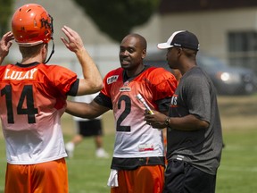 Quarterbacks Kevin Glenn and Travis Lulay speak with Offensive Coordinator Khari Jones during practice in Surrey, BC, August, 5, 2014. (Richard Lam/PNG)