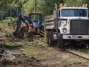 Crews clear the land next to the CP rail line along East Boulevard in Vancouver on Aug. 15, 2014. Cleta Brown argues the company and city are missing the big picture while locked in a dispute over encroaching gardens.