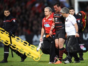 Toulouse's French centre Florian Fritz leaves the pitch after he was injured during the Top 14 quarter-final rugby union match between Stade Toulousain and Racing Metro at the Ernest Wallon stadium in Toulouse, on May 9, 2014.   (REMY GABALDA/AFP/Getty Images)