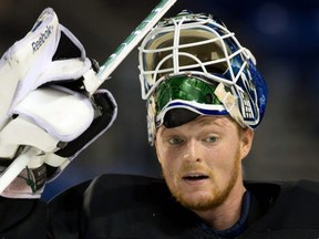 File-This Jan. 8, 2013 file photo shows Vancouver Canucks goalie Cory Schneider leaving the ice after an informal hockey practice at the University of British Columbia in Vancouver, British Columbia. The New Jersey Devils have acquired Schneider from the Vancouver Canucks for the ninth pick in the NHL draft (AP Photo/The Canadian Press, Darryl Dyck) ORG XMIT: NY150