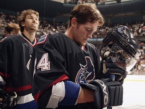 Matt Cooke stands for the anthems before a game against the San Jose Sharks in 2003.