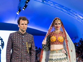 Caleb Matthews of DEJA VU Model Management and Miss India and Universe 2008 Simran Kaur Mundi model designs from artist and designer Shravan Kumar at Vancouver Fashion Week spring/summer 2015