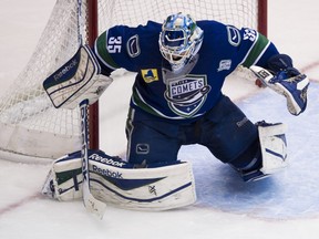 ABBOTSFORD. NOVEMBER 29 2013. Utica Comets goalie Joe Cannata stops a shot by the Abbotsford Heat in the third period of a regular AHL hockey game at the AESC, Abbotsford November 29 2013.  Gerry Kahrmann/PNG)