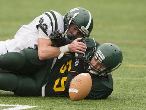 Argyle's Liam Baird (bottom) and Jeremie Cheng of the Nanaimo District Islanders battle to recover fumble during Double A high school football action Friday in North Vancouver. (Richgard Lam, PNG)