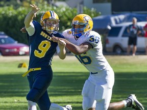 Under pressure, South Delta quarterback Lucas Kirk gets the ball downfield against the Handsworth Royals in Triple A action Saturday in Tsawwassen. (Jenelle Schneider, PNG)