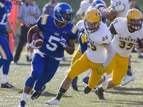 UBC's Marcus Davis (5) outruns the Alberta Golden Bears en route to a two-TD day Saturday as UBC won its first game of the 2014 season. (Wilson Wong, UBC athletics)